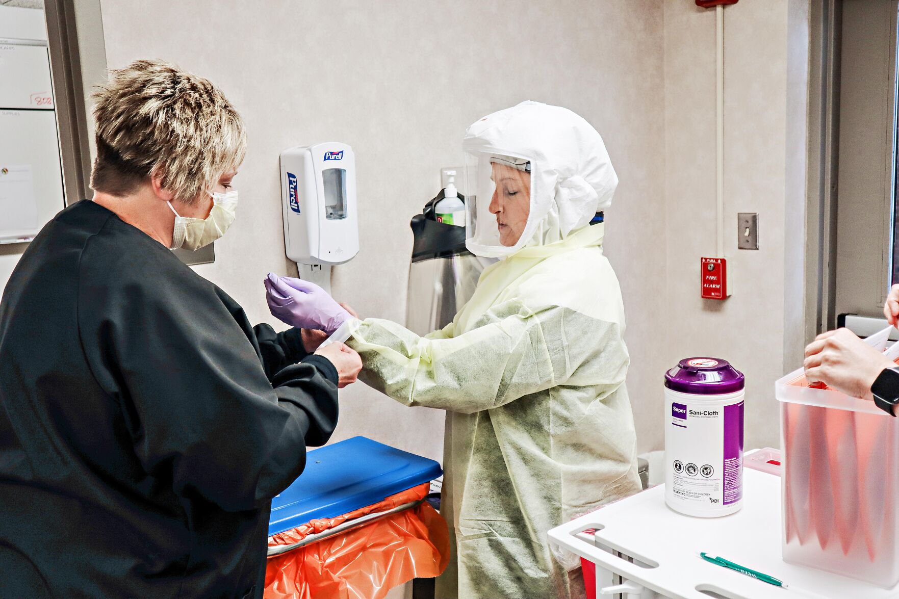Lab staff don PPE for COVID-19 collections